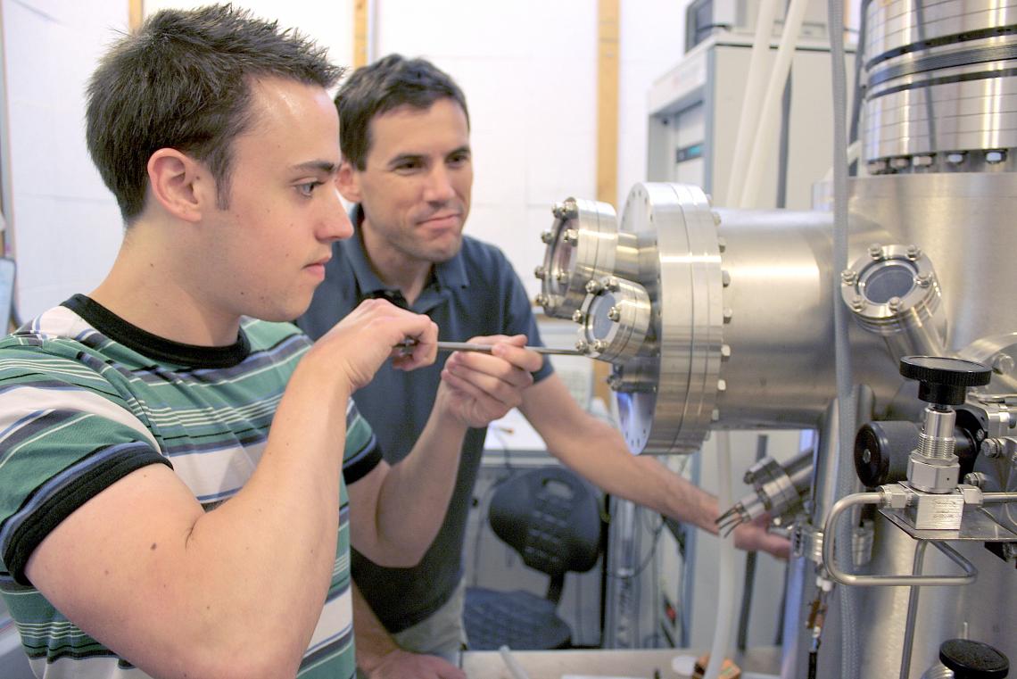 Brian LeRoy, UA associate professor of physics and graduate student and first author of the study, Matthew Yankowitz, use a tunneling electron microscope to probe the electronic properties of graphene.